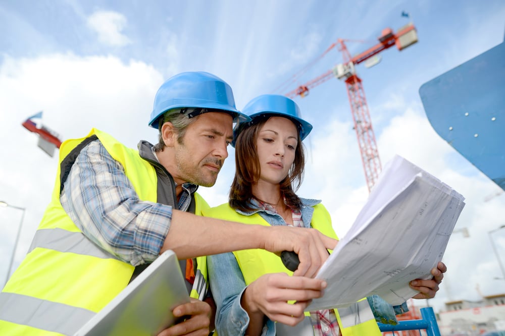 Construction manager and engineer working on building site-1